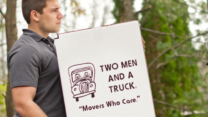 professional moving services - movers carrying boxes