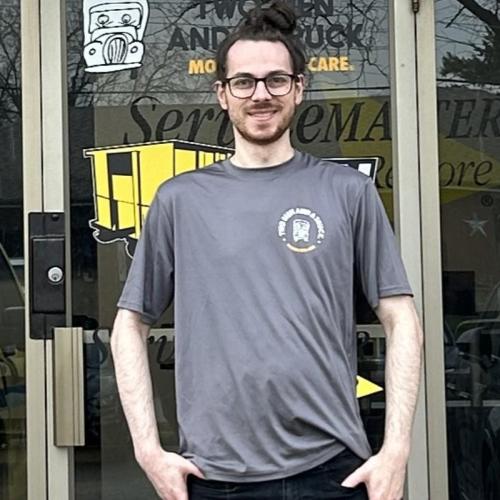 Jon- mover with two men and a truck standing in front of company door