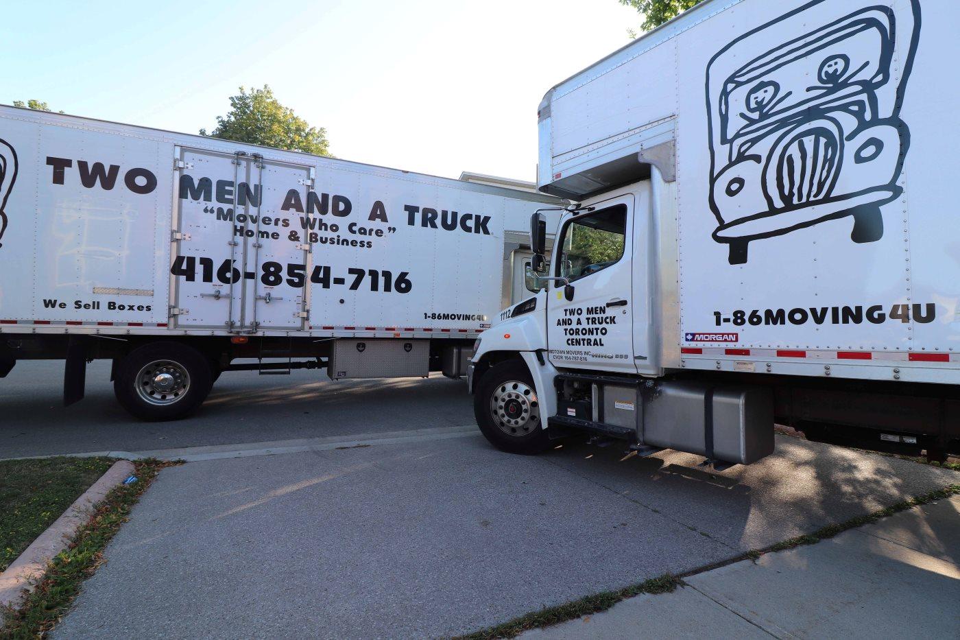 two moving trucks in a parking lot